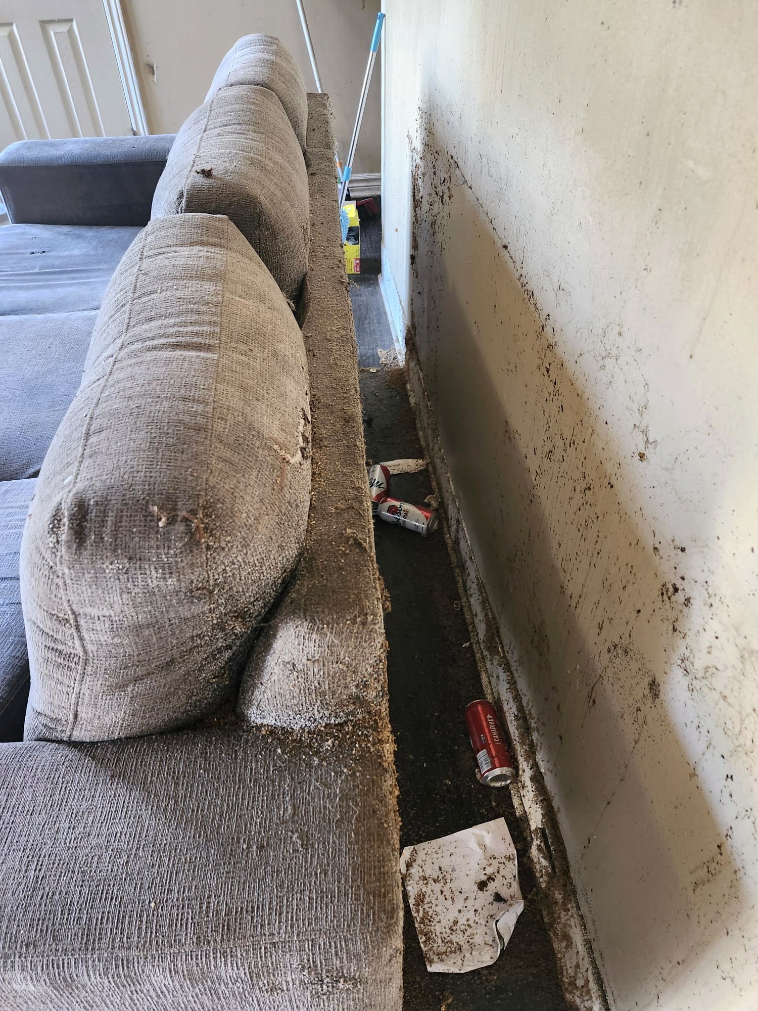 Heavily soiled sofa and walls before restoration cleaning