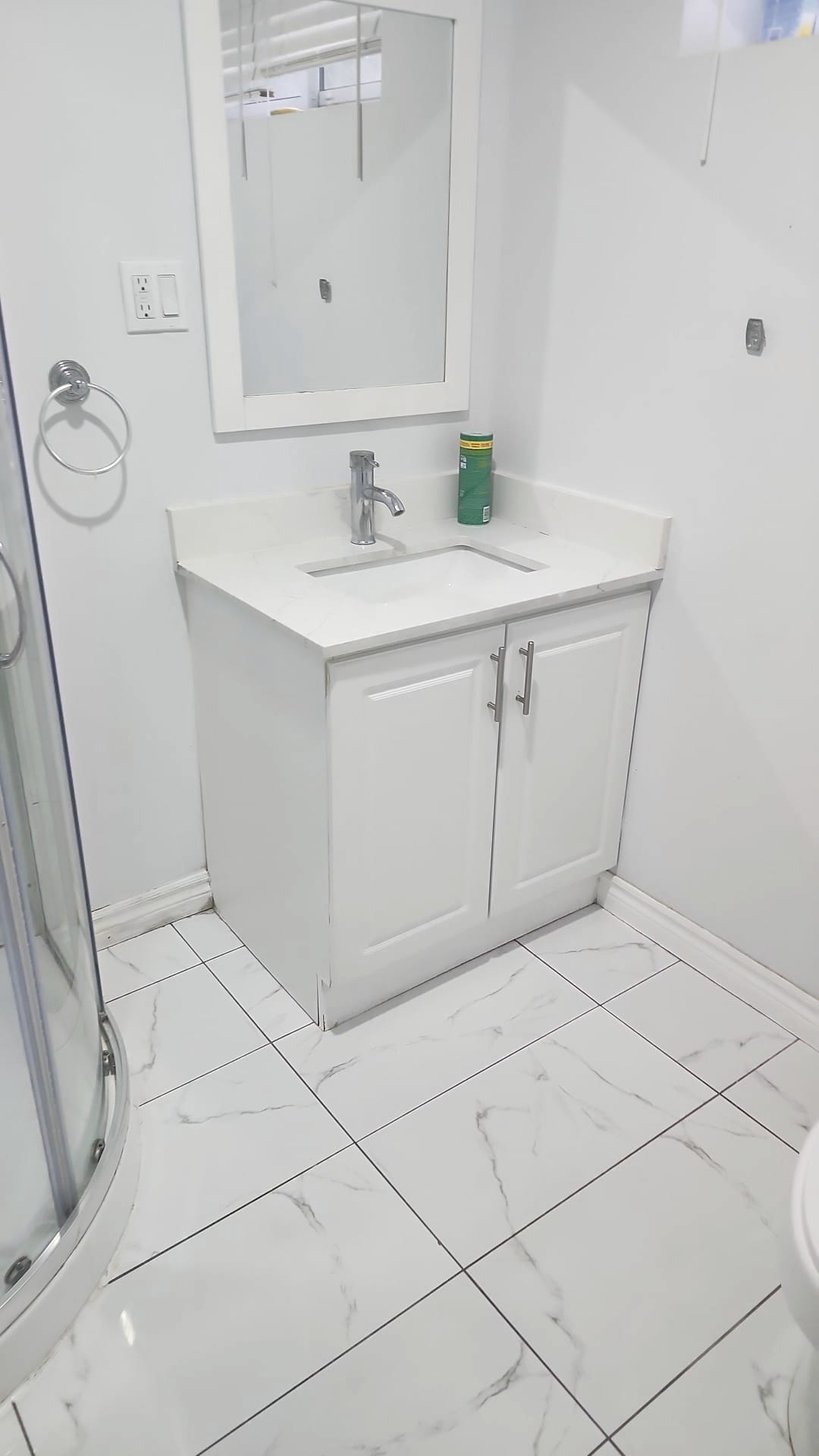 Bright white bathroom vanity and tile floor after deep cleaning