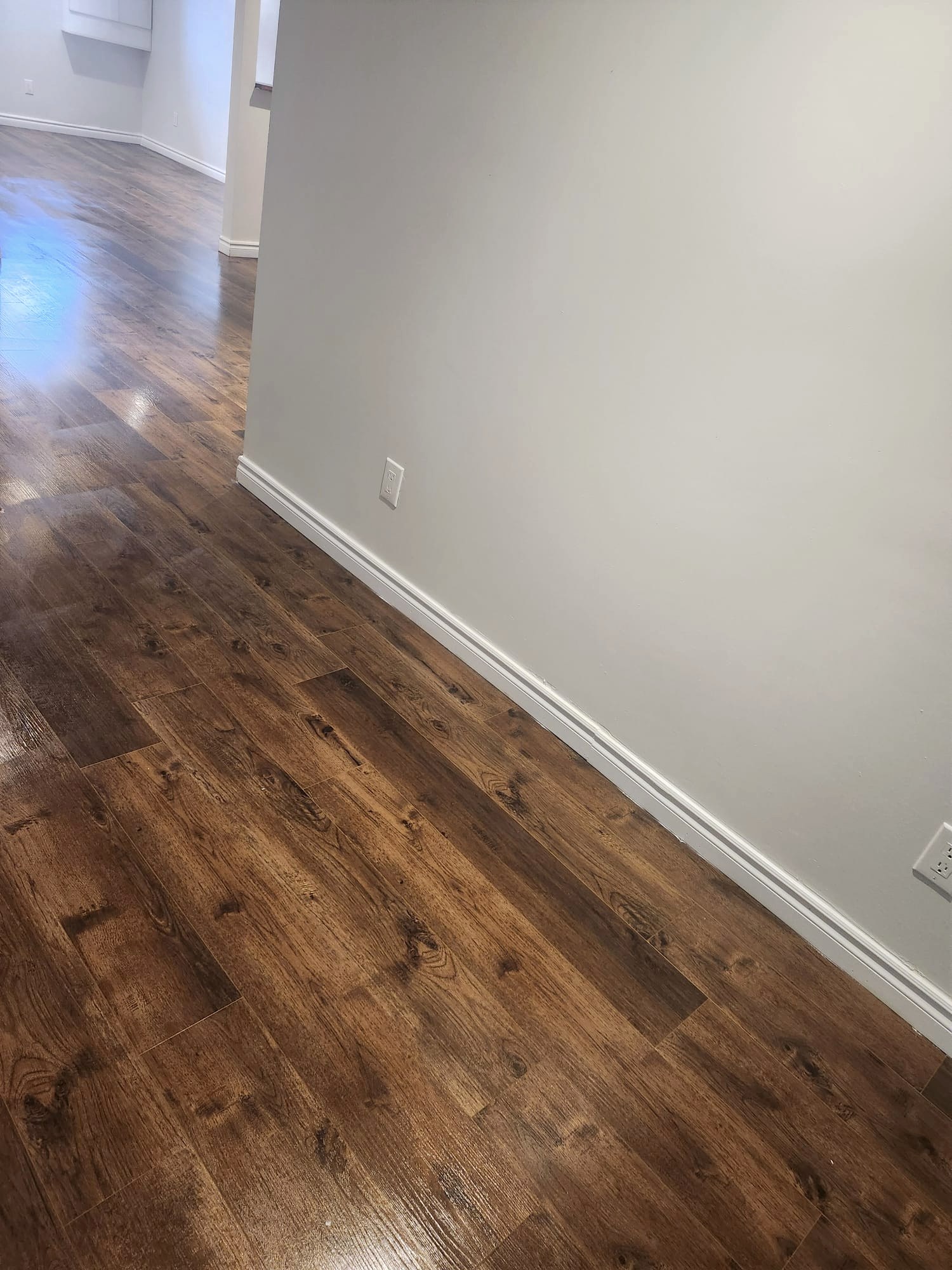Close-up of polished hardwood floors and clean baseboards