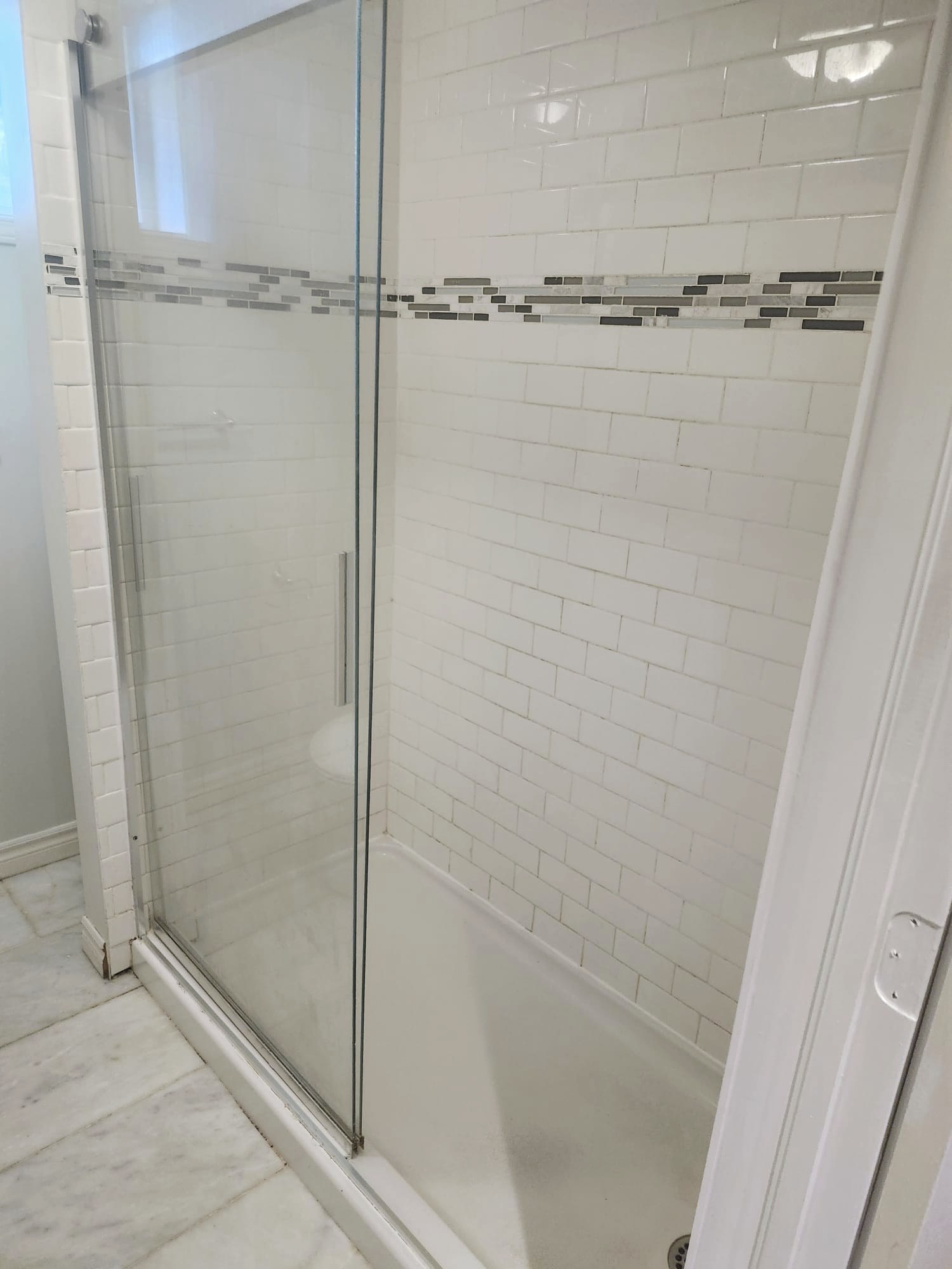 Spotless subway tile shower with streak-free glass door